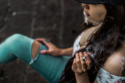 Close-up of young woman smoking cigarette