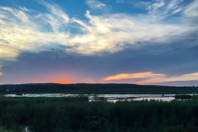 Scenic view of lake against sky during sunset