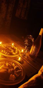 High angle view of illuminated candles on table