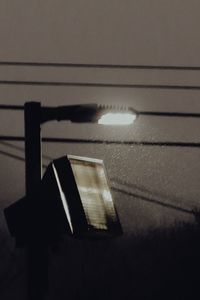 Close-up of illuminated light bulb on wall