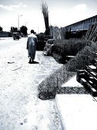 Full length of woman standing against sky