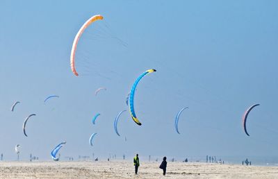 Scenic view of kites against sky