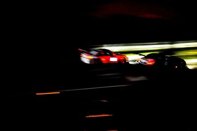 Blurred motion of car on road at night