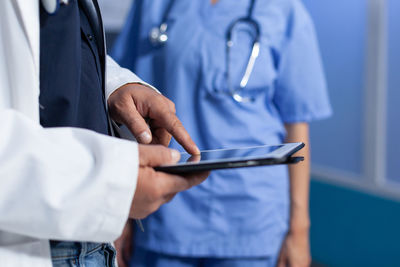 Midsection of man using mobile phone