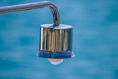 Close-up of padlock on blue water