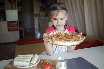 Girl holding sweet food at home