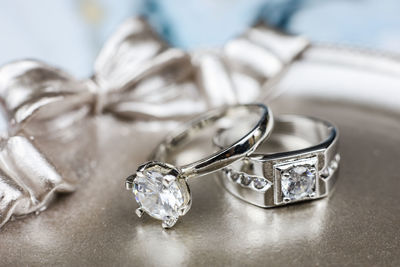 Close-up of wedding rings on table