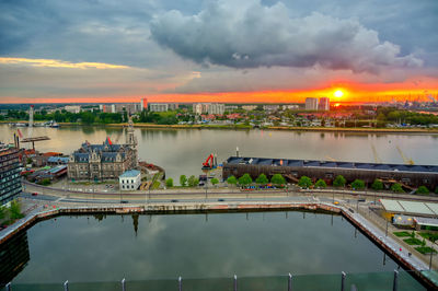 Bridge over river against sky during sunset