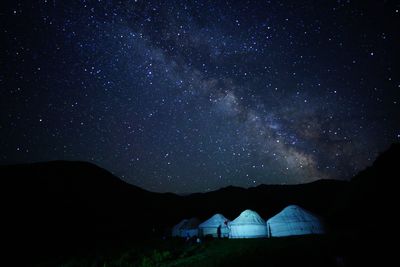 Scenic view of mountains against sky at night