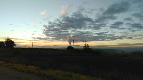 Scenic view of field against sky during sunset