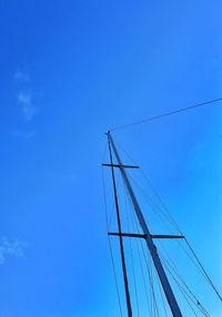 Low angle view of sailboat against clear blue sky