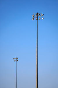 Low angle view of floodlight against clear blue sky