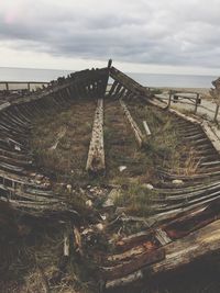 Abandoned built structure on field against sky