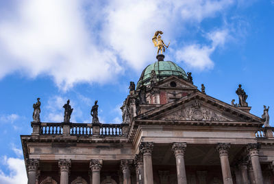 Low angle view of statue against cloudy sky