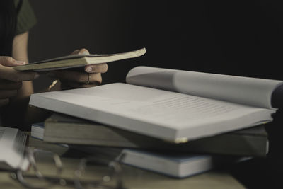 Midsection of woman using mobile phone at table