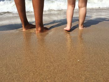 Low section of woman walking on beach