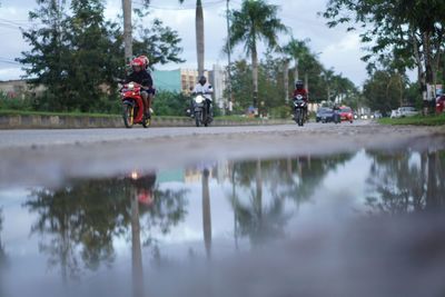 People riding bicycle on water