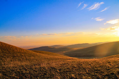 Scenic view of landscape against sky during sunset