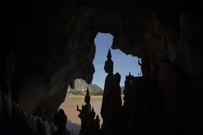 Silhouette statues in cave