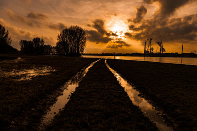 Scenic view of lake against dramatic sky