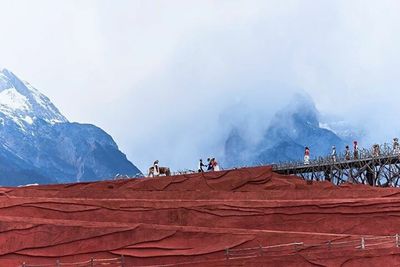 Scenic view of mountains against cloudy sky