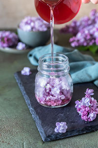 Preparation of syrup from the lilac flowers. glass jar of homemade lilac syrup 