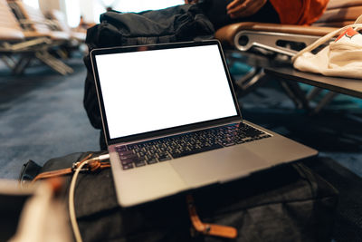 Midsection of woman using laptop on table