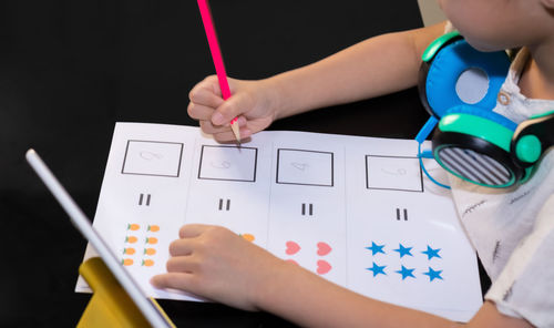 Close-up of boy playing with paper