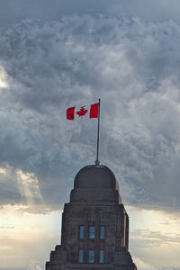 Low angle view of building against cloudy sky