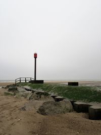 Lifeguard hut on beach against sky