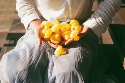 Close-up of woman holding yellow flower