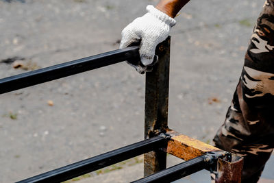 High angle view of man standing by metallic structure outdoors