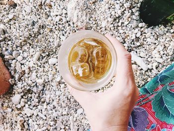 High angle view of hand holding drink