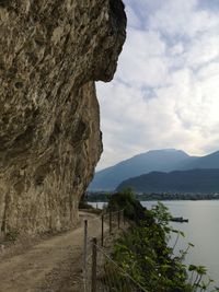 Scenic view of lake by mountains against sky