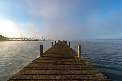 Pier over sea against sky