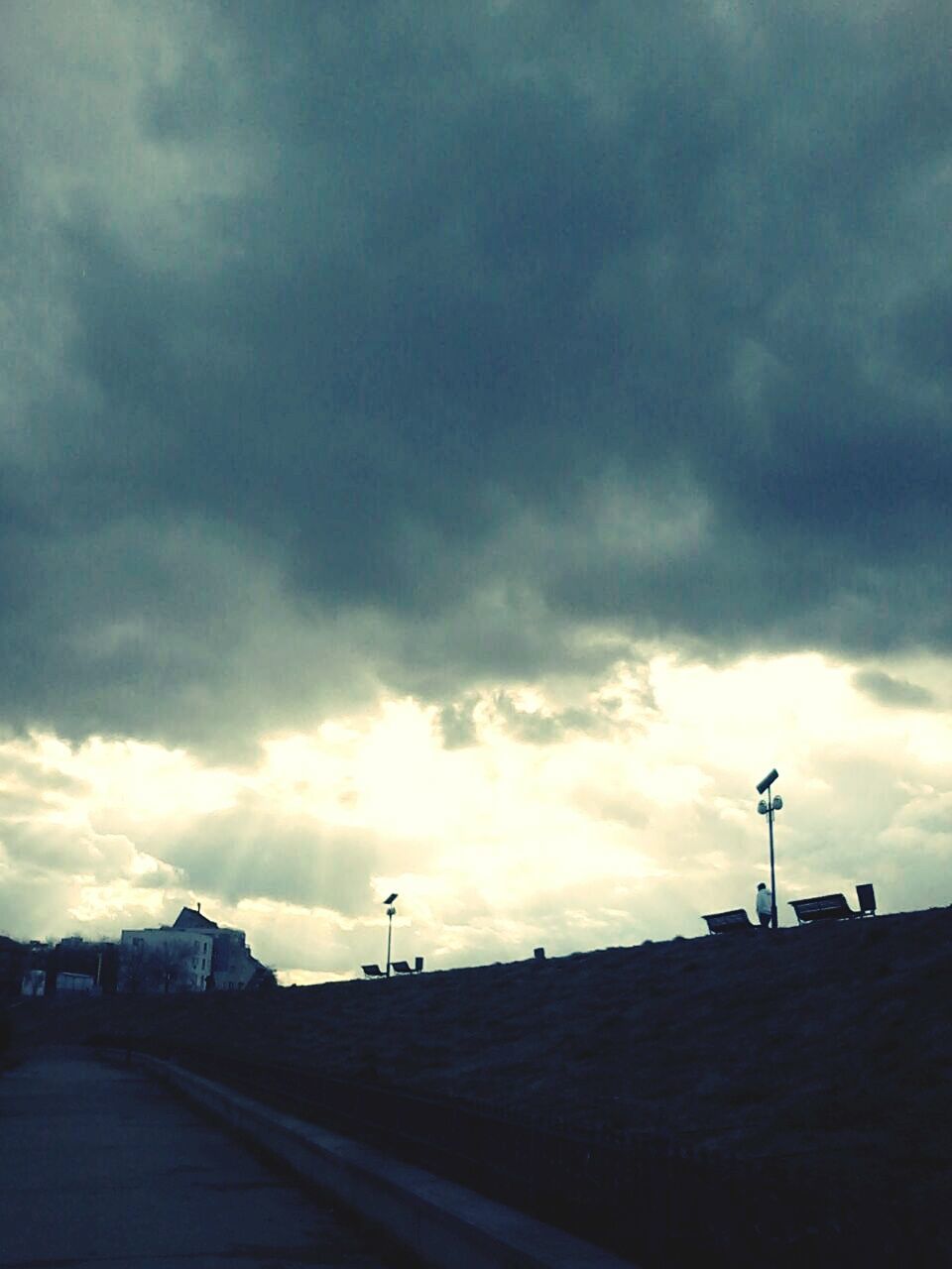 sky, cloud - sky, cloudy, the way forward, street light, road, cloud, transportation, overcast, built structure, silhouette, weather, architecture, building exterior, street, dusk, dramatic sky, storm cloud, outdoors, sunset