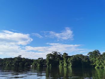 Scenic view of lake against blue sky