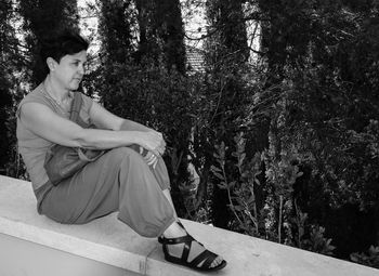 Young woman sitting in forest