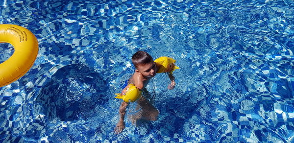 High angle view of woman swimming in pool