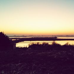 Scenic view of lake at sunset