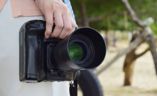 Close-up of man photographing camera