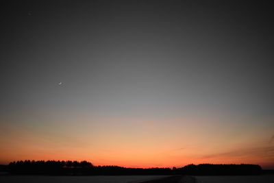 Scenic view of silhouette field against clear sky at night