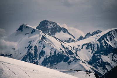 Scenic view of snow covered mountains against sky