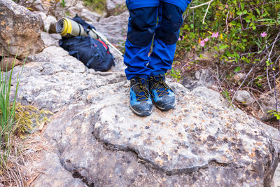 Low section of man standing on rock