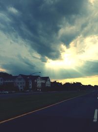 Road against cloudy sky at sunset