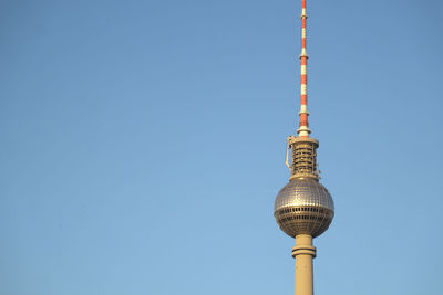 Low angle view of communications tower against sky