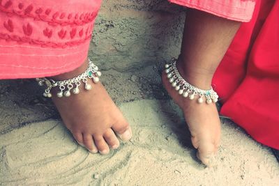 Low section of women with baby feet
