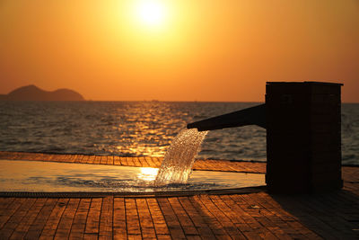 Scenic view of sea against orange sky