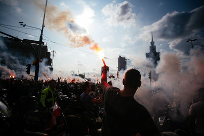 People standing in front of buildings against sky