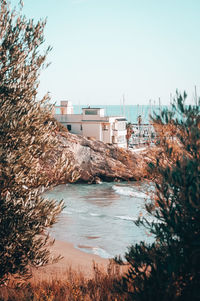 River amidst buildings against clear sky